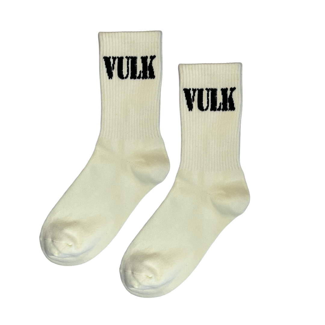 Pair of cream socks with 'Vulk' branding on a clear background